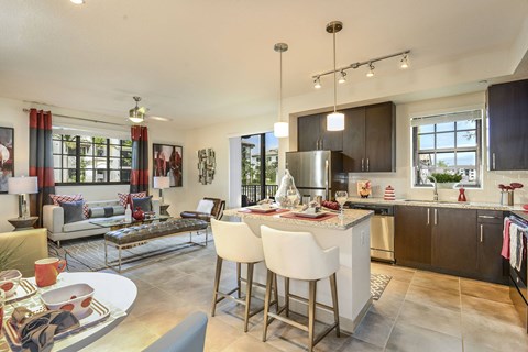 a kitchen and living room with a table and chairs